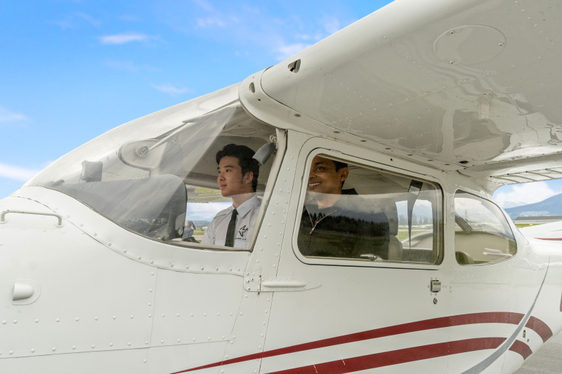 An instructor with a student in aircraft
